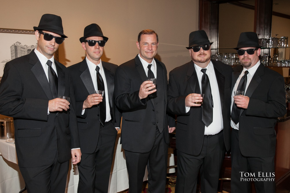 Groom and groomsmen (in hats and sunglasses) raise a toast before the wedding ceremony at the Sorrento Hotel