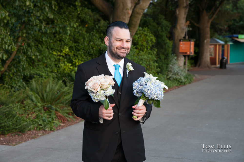 The best man doing double-duty as flower holder for the bride and maid of honor