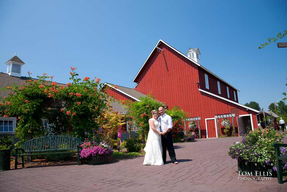Bride and groom at Pickering Farm, with Dairy Barn and Hay Barn in the background
