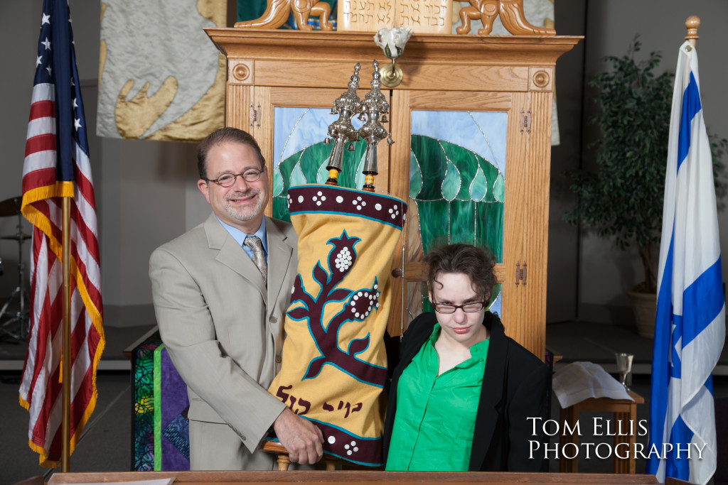 Becca and the rabbi hold the Torah in front of the Arc at her Bat Mitzvah ceremony