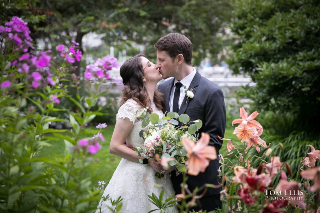 Mandy and Rob share a kiss in one of the garden areas at the Ballard Locks, shortly after getting married at Ray's Boathouse