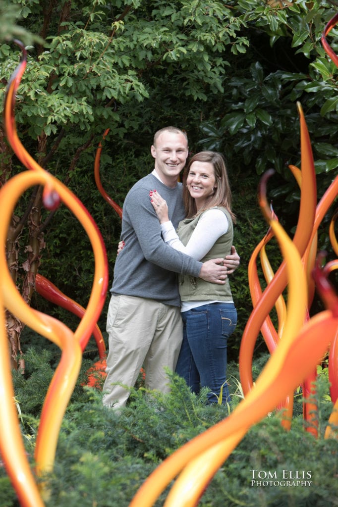 Jess and Steven hug for the camera after Steven's surprise marriage proposal at Seattle's Chihuly Glass Garden