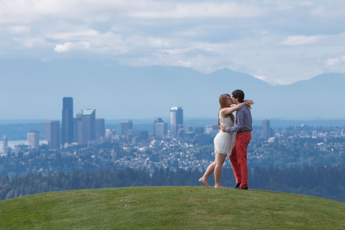 Couple kissing on top of the Kite Hill during engagement photo session at Gasworks Park