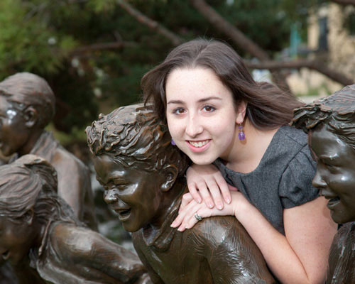 Senior girl leaning on sculptures at Marina Park in Kirkland