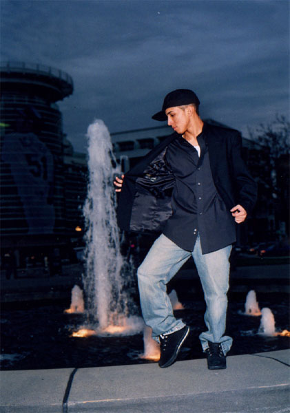 Senior boy posing in front of fountian at Seattle Center