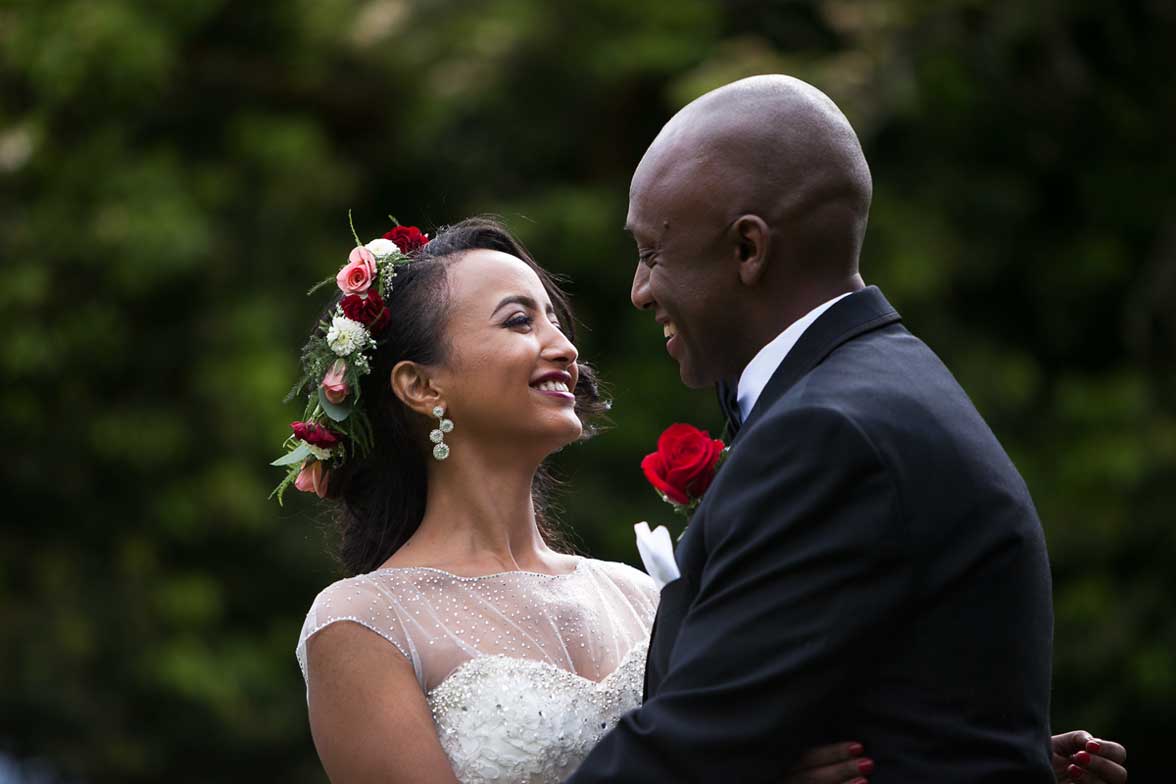 Seattle wedding photographer Tom Ellis Photography. Romantic close-up photo of Ethiopian bride and groom as they share a laugh together