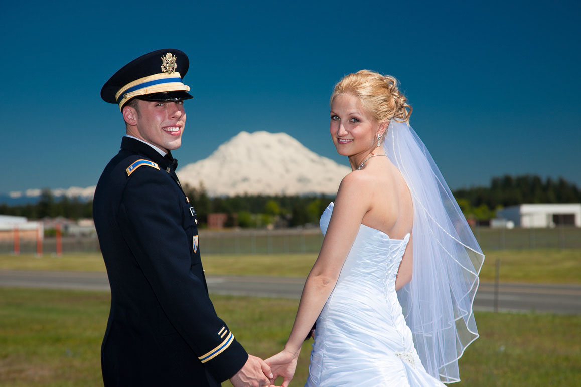Bride with groom in military dress uniform at Fort Lewis, Mt Rainier in the baqckground