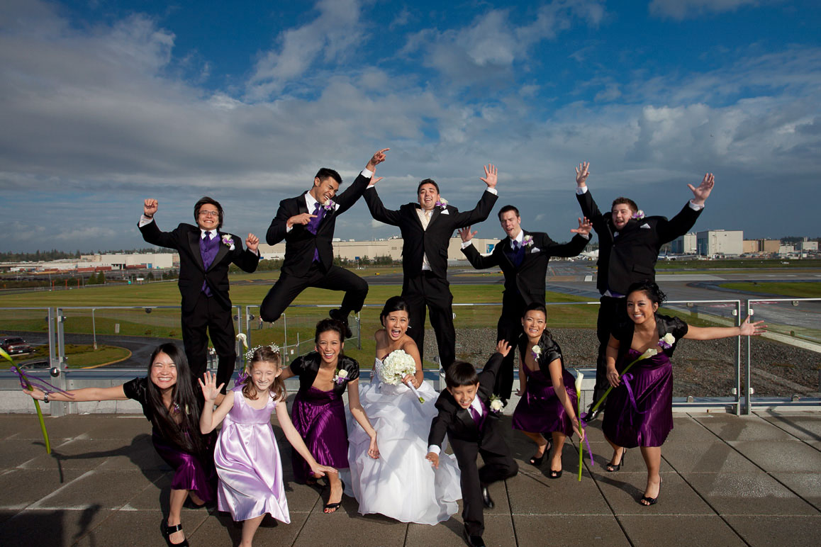 Seattle wedding photographer Tom Ellis Photography. Wedding party getting crazy on the rooftop at Future of Flight museum in Mukilteo