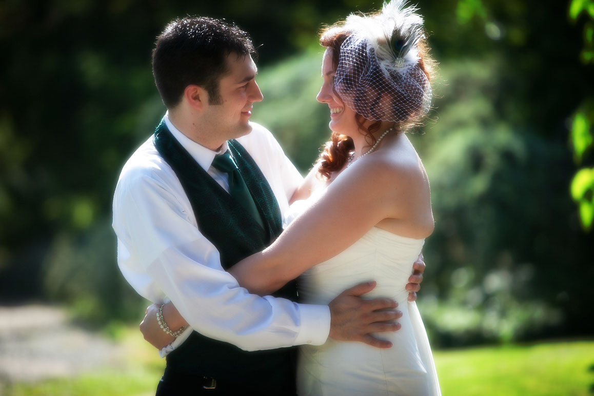 Seattle wedding photographer Tom Ellis Photography. Backlit photo of bride and groom hugging at Kubota Garden in Seattle