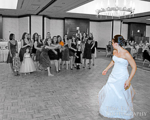 Bride tossing bouquet at Bellevue Hilton wedding