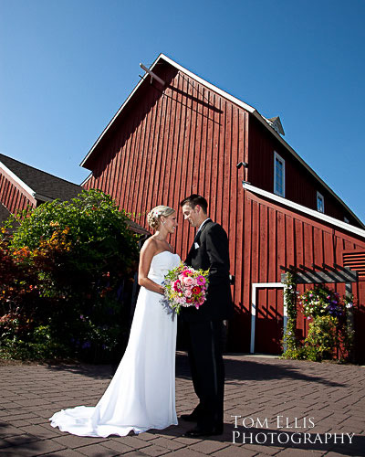 Bride and groon outside red barn at Pickering Barn in Issaquah