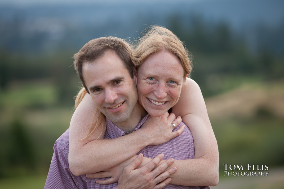 Rene gives Dan a big hug during their engagement photography session at Newcastle Golf Club