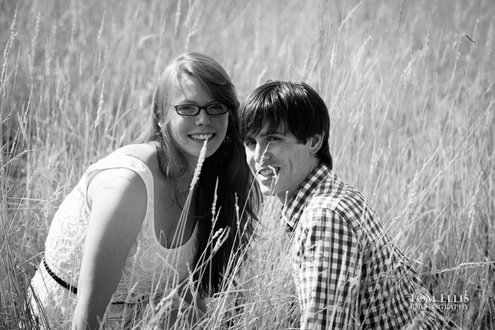 Trevor and Aurora in the tall grass at Newcastle Golf Club during their engagement photography session