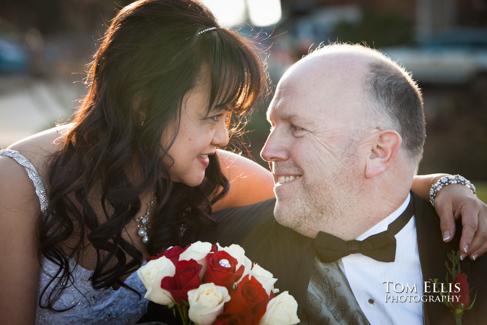 Close up photo of bride and groom looking at each other