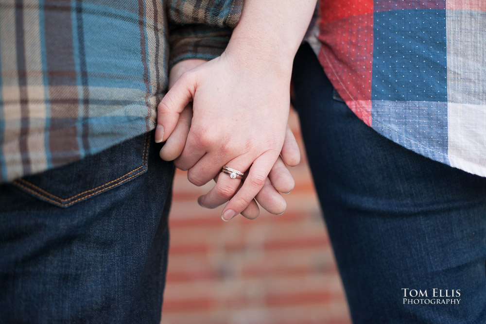 Close up photo of engaged couples hands and engagement ring