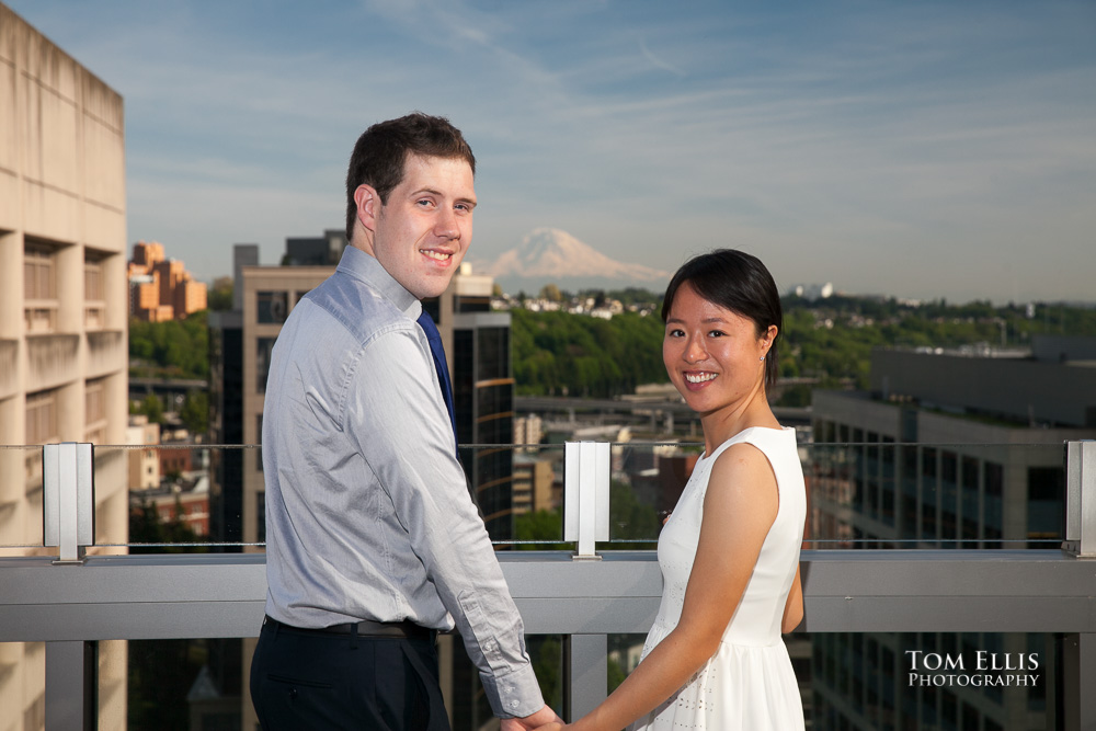 Bride and groom turn to face the camera at their Seattle courthouse wedding, with Mt Rainier in the background