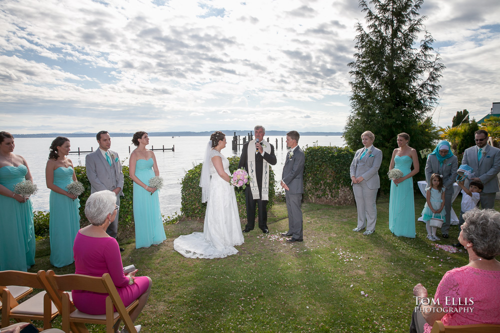 Same sex wedding ceremony at beach venue, Puget Sound in the background