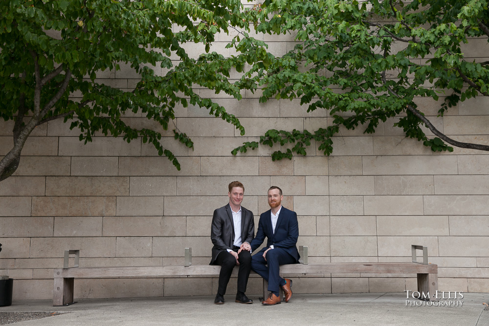 Newlywed gay couple sit together on a bench outside Seattle City Hall