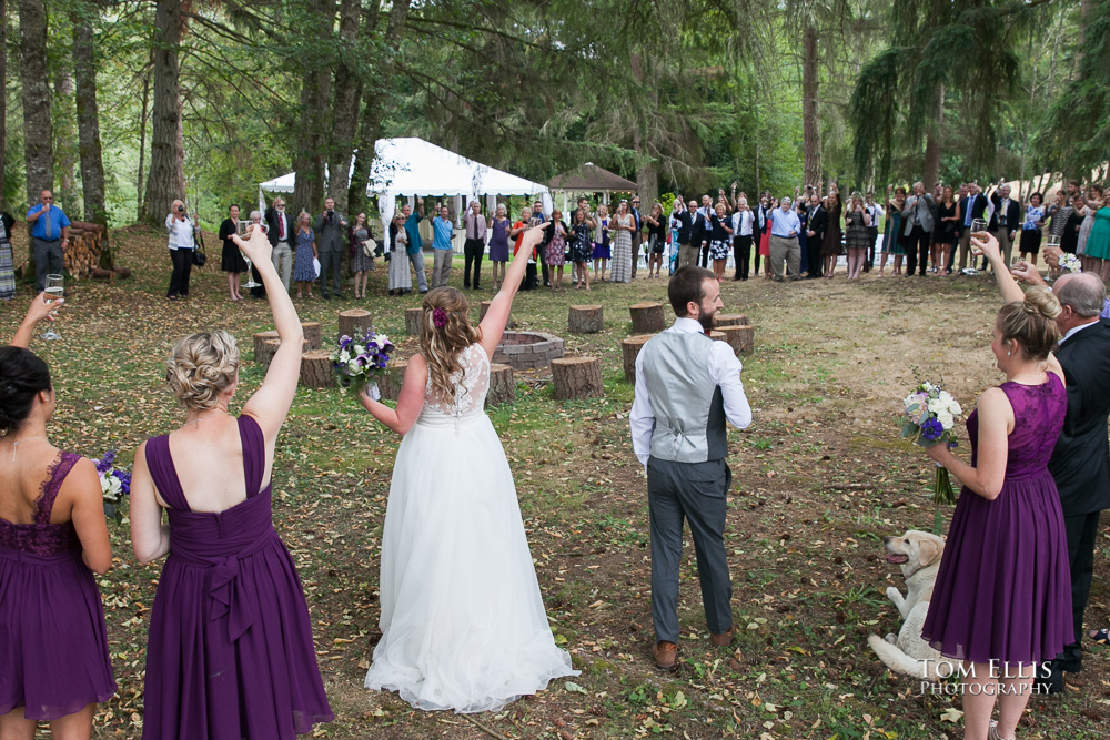 Bride, groom, wedding party and guests gather in a large circle after their wedding ceremony at the Kingston House