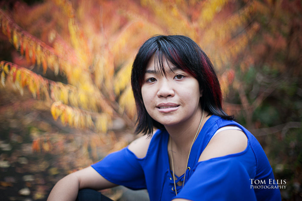 Melissa during her Seattle are senior photo session, posed with an amazing background of fall colors