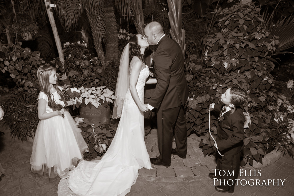 Bride and groom kiss at the conclusion of their wedding ceremony at the Seymour Conservatory in Wright Park