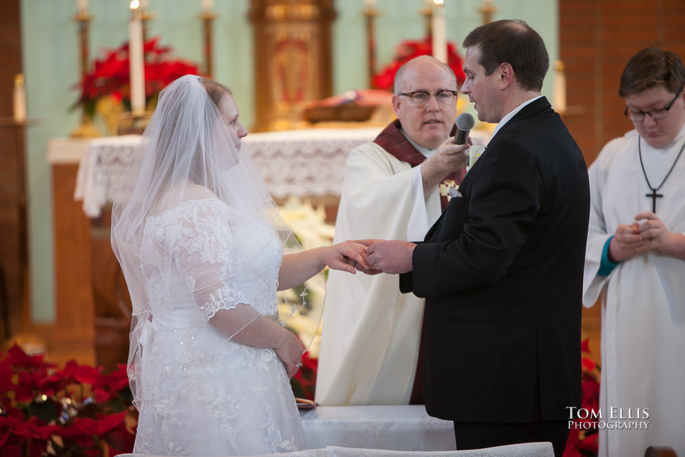 Bride and groom exchange rings during their Seattle area wedding ceremony