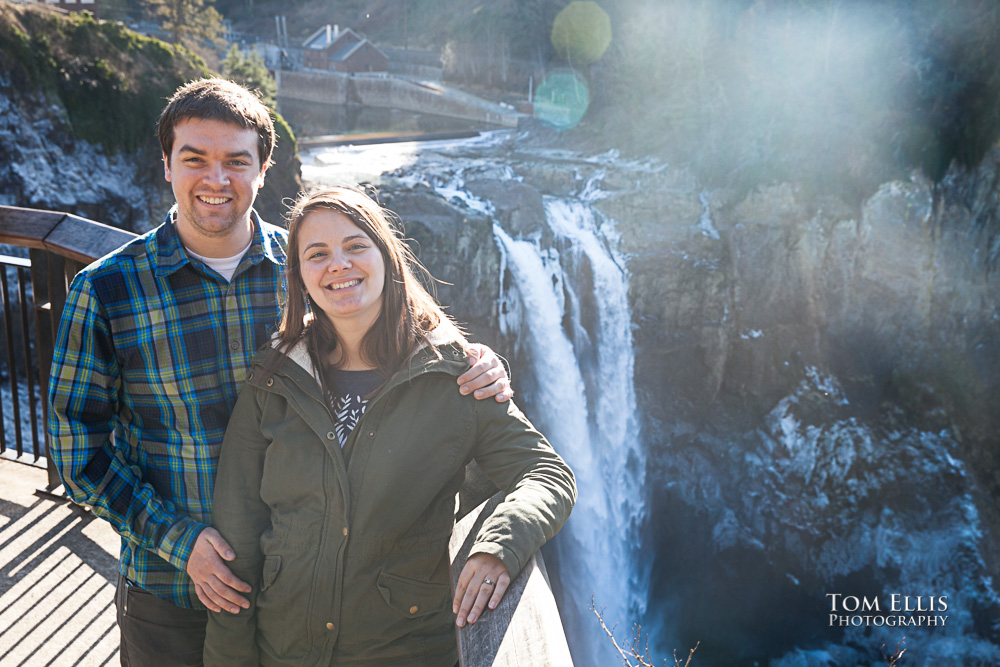 Engagement photo at Snoqualmie Falls with Falls and icy spray in background