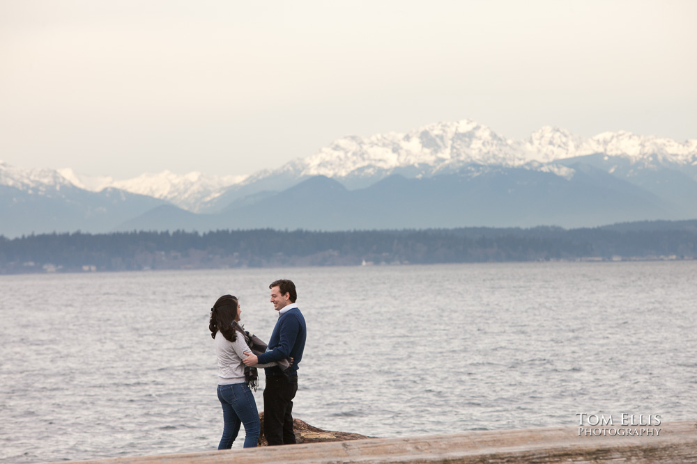 Engaged couple on the beach at Golden Gardens Park in Seattle