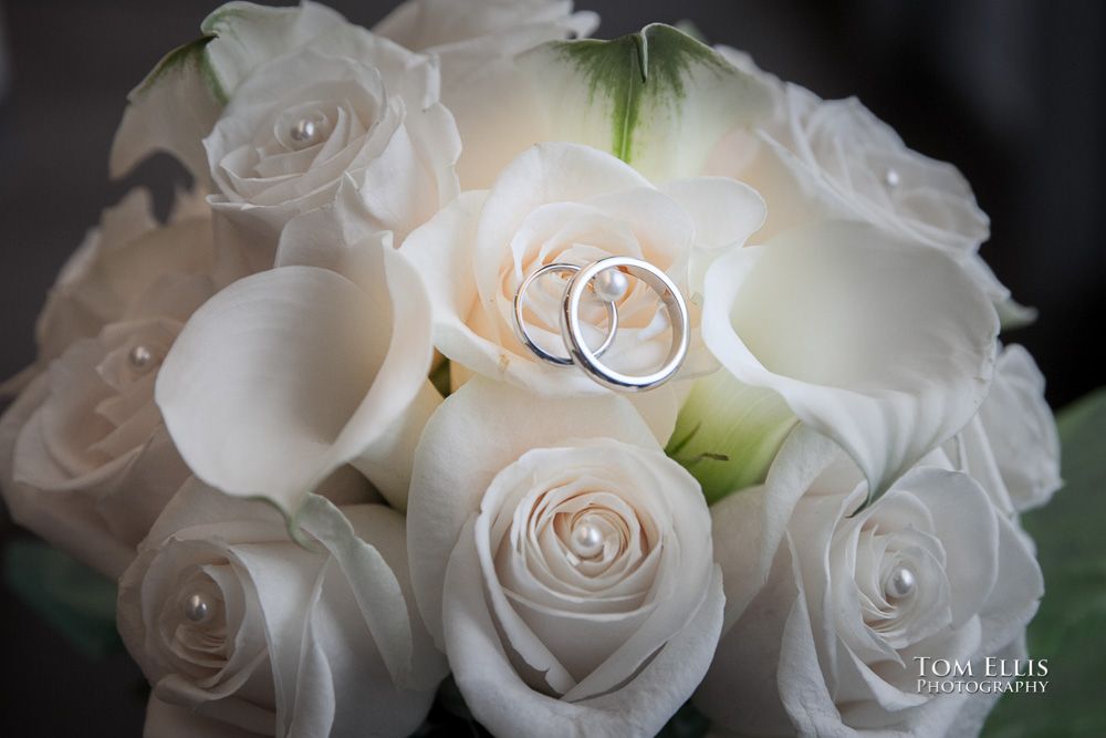 Close up photo of bridal bouquet with the bride's and groom's rings inside one of the flowers, at their wedding at the Seattle Municipal Courthouse