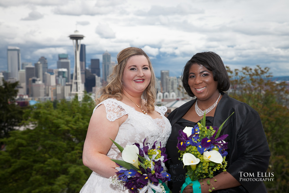 Two brides pose for photo at Seattle's Kerry Park, with the Space Needle in the background