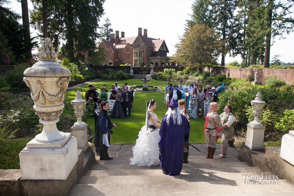 Costume wedding ceremony in the formal garden at Thornewood Castle