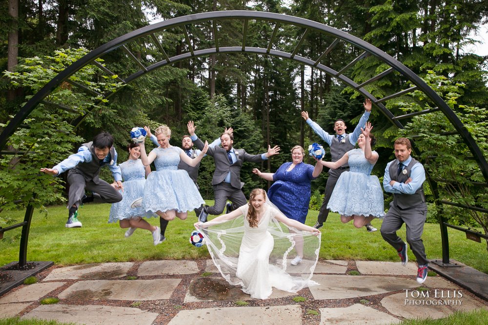 Wedding party jumps for joy at an outdoor wedding ceremony at Dragonfly Retreat