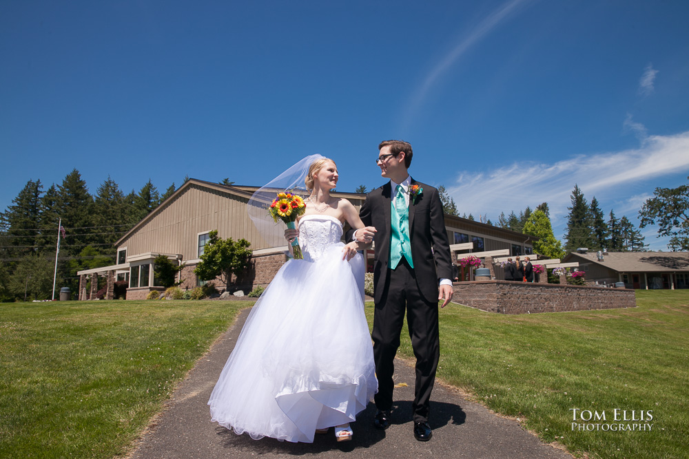 Bride and groom walk together after their wedding ceremony on a beautiful summer day