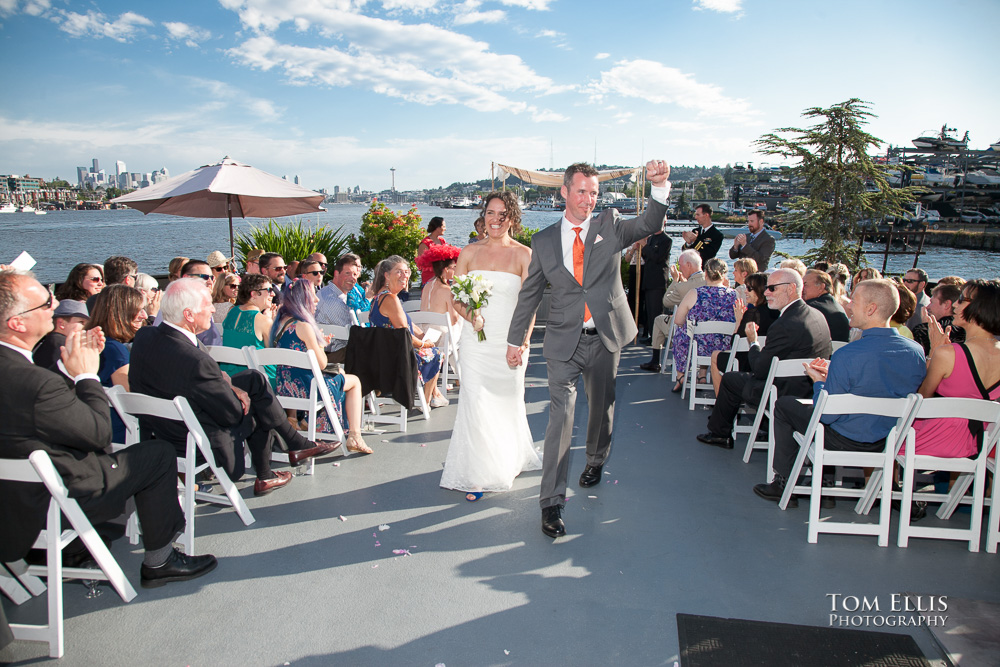 Bride and groom come down the aisle together at the conclusion of their Seattle wedding ceremony on the Skansonia Ferryboat