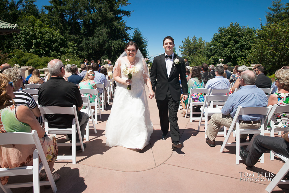 Bride and groom recess down the aisle at the conclusion of their wedding ceremony at the Pagoda in Point Defiance Park