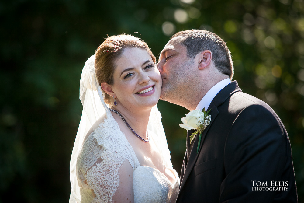 Groom gives bride a kiss on the cheek before their wedding at Tibbett's Creek Manor