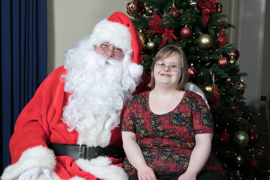 Santa poses with young woman with Down Syndrome at the 2017 Special People's Holiday Cruise