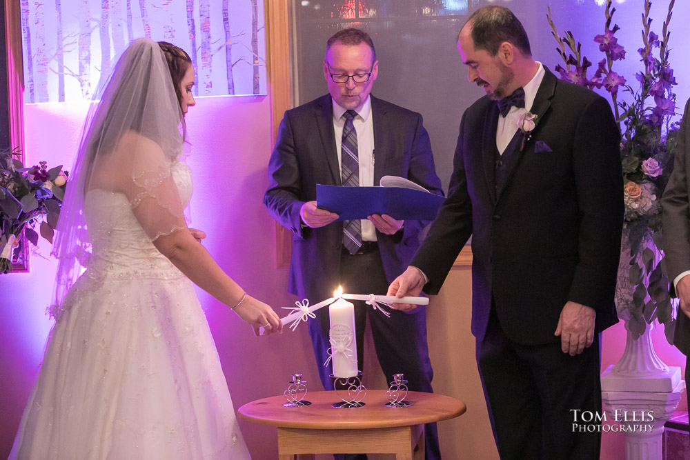 Bride and groom light their Unity Candle during their Seattle area wedding ceremony at Bistro 76 Cafe and Catering