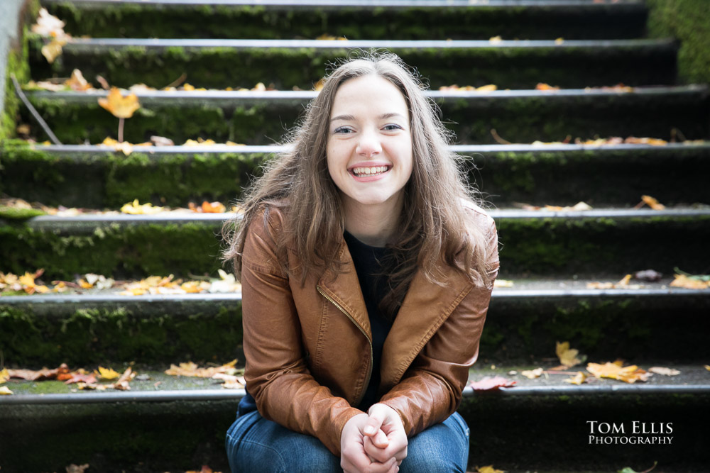 High school senior girl sitting on old concrete steps during her senior photo session with Tom Ellis Photography