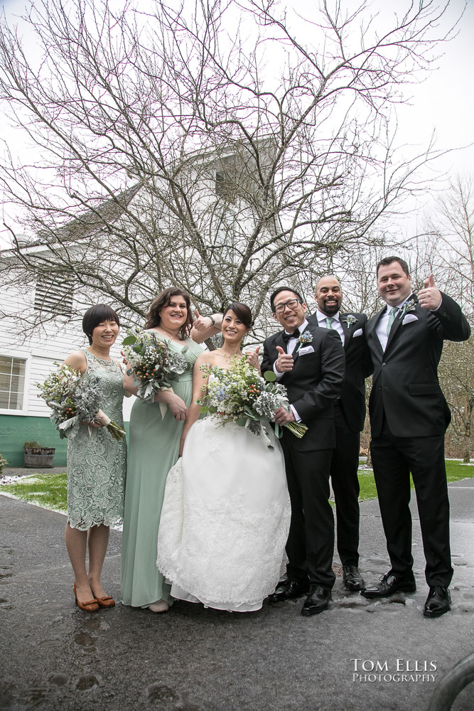 Wedding party stands outdoors in a snowstorm before the wedding ceremony at Russell's Loft, photographed by Tom Ellis Photography, top-rated Seattle wedding photographer