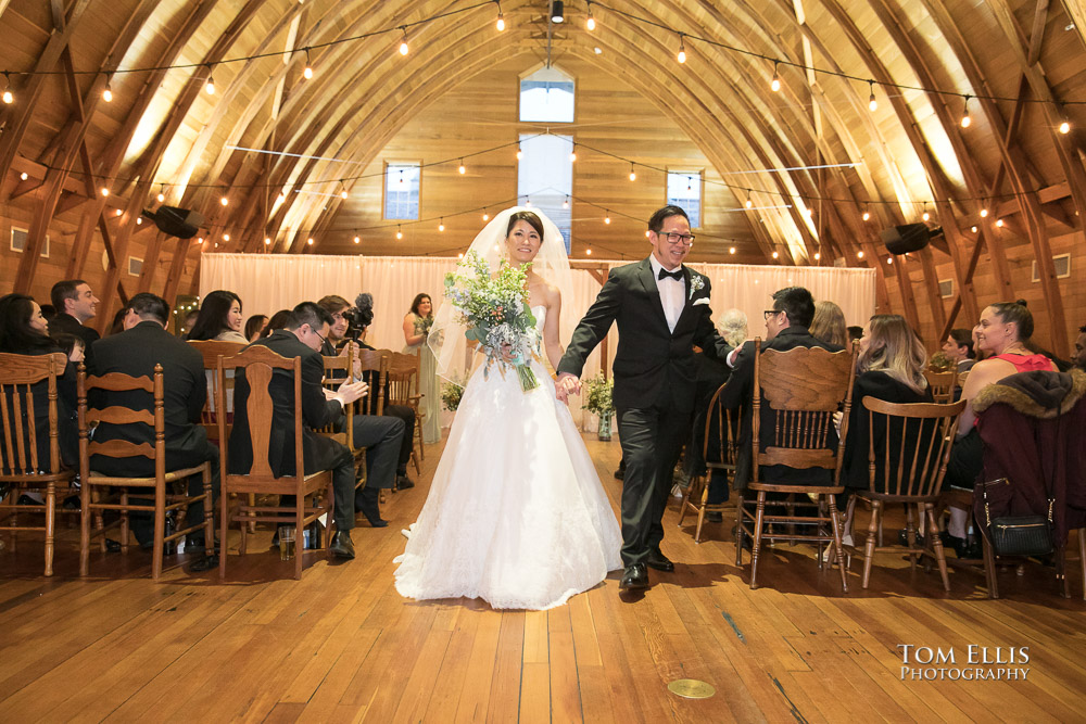 Bride and groom recess down the aisle at the conclusion of their Seattle area wedding ceremony at Russell's Loft