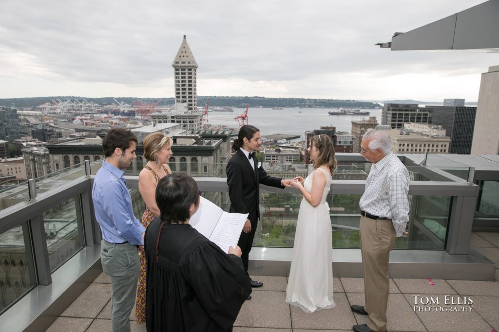Couple getting married in an elopement wedding ceremony on the roof of the Seattle Municipal Courthouse