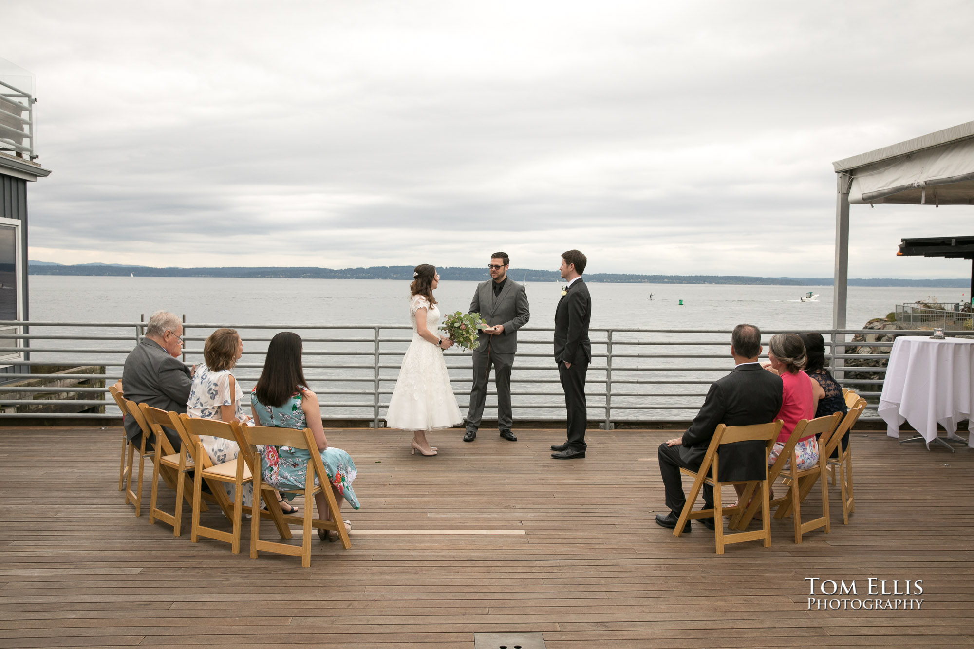 Mandy and Rob get married in an outdoor ceremony on the deck at Ray's Boathouse in Seattle, with Puget Sound as the background