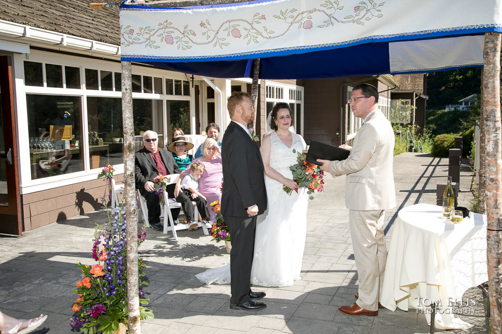 Shayna and Charles under the chuppa with their rabbi during their Jewish wedding ceremony at the Salish Lodge