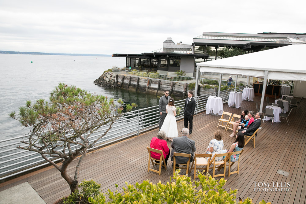 Elopement wedding ceremony at Ray's Boathouse in Seattle, with a background of Shilshole Bay and Puget Sound
