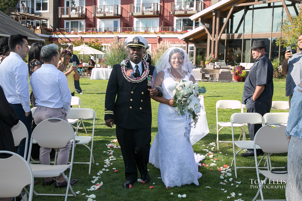 Brid and her father start down the aisle at her beautiful outdoor destination wedding ceremony at Clearwater Resort, photographed by Seattle wedding photographer Tom Ellis Photography