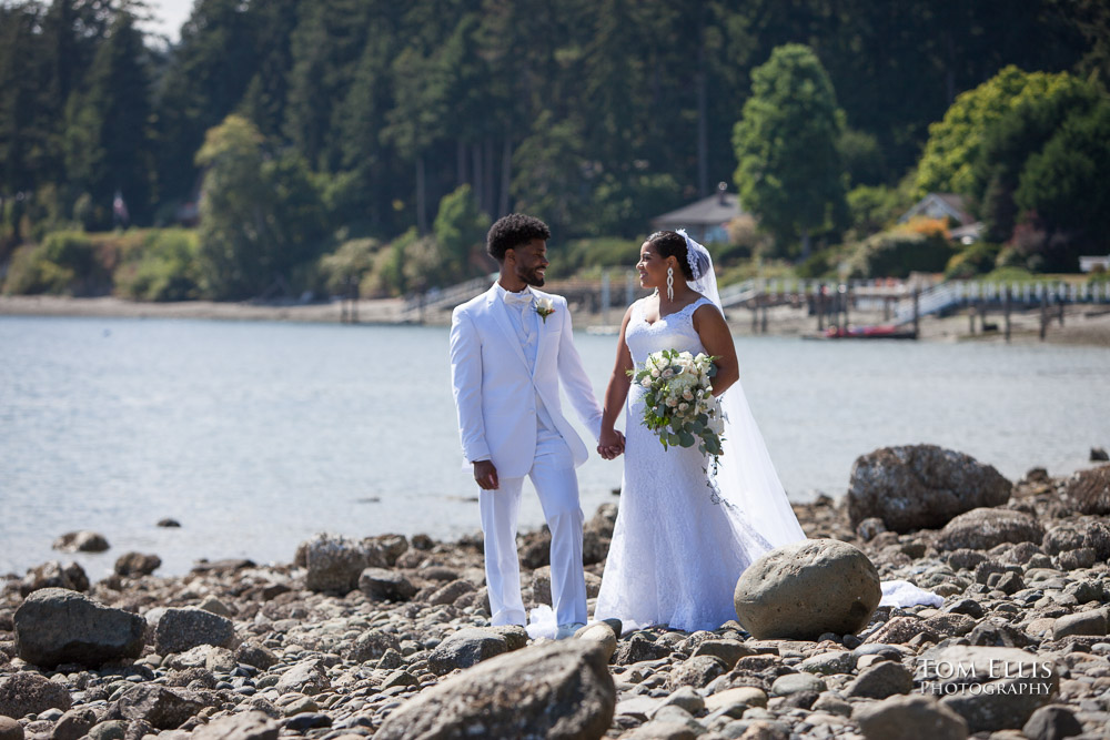 Bride and groom stand together on a beautiful beach shortly before their wedding ceremony at Clearwater Resort. Tom Ellis Photography, destination wedding photographer