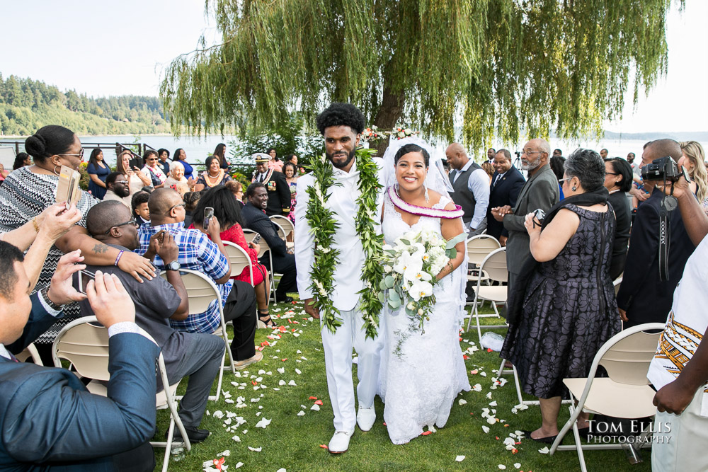 Bride and groom come down the aisle at the conclusion of their wedding ceremony at the Clearwater Casino Resort, photographed by Seattle's top destination wedding photographer, Tom Ellis Photography