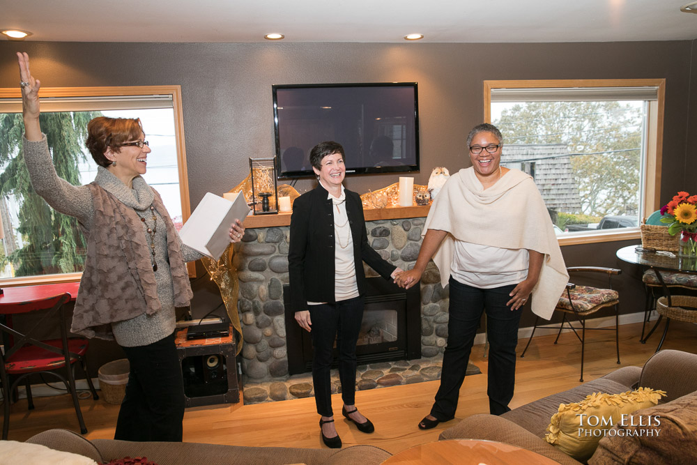 Two brides and the officiant celebrate at the conclusion of the same-sex elopement wedding ceremony. Tom Ellis Photography, Seattle's premier wedding photographer