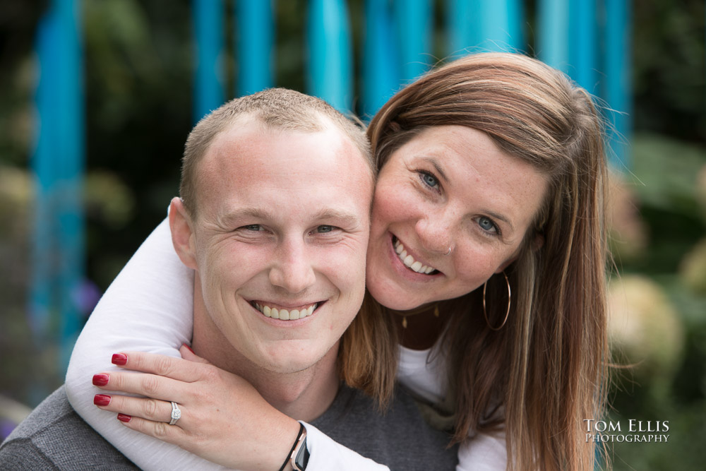 Close up photo of Jess and Steven as Jess shows off her new engagement ring, just given to her after Steven's surprise proposal at the Chihuly Glass Garden.